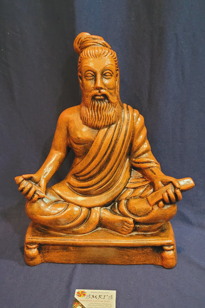 Thiruvalluvar sitting statue Orange wood color  showpiece table décor office décor papermache ( 13 H * 10 L * 5.5 W ) Inches