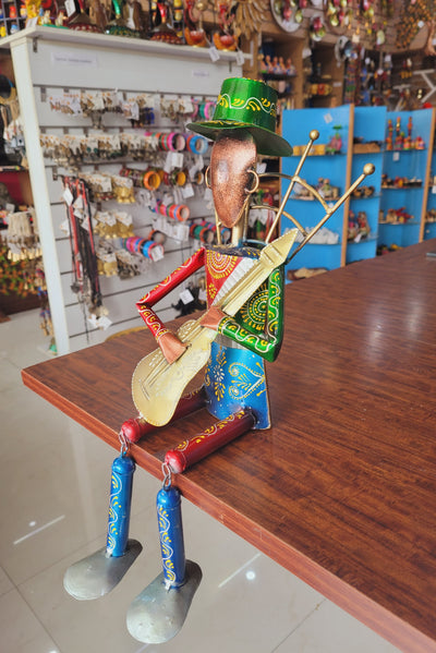 Musician Man with Guitar Green Cap with swinging legs Table Decor Iron (7L * 7W * 17H) inches Showpiece Return Gift Corporate Gift Showpiece Return Gift Corporate Gift